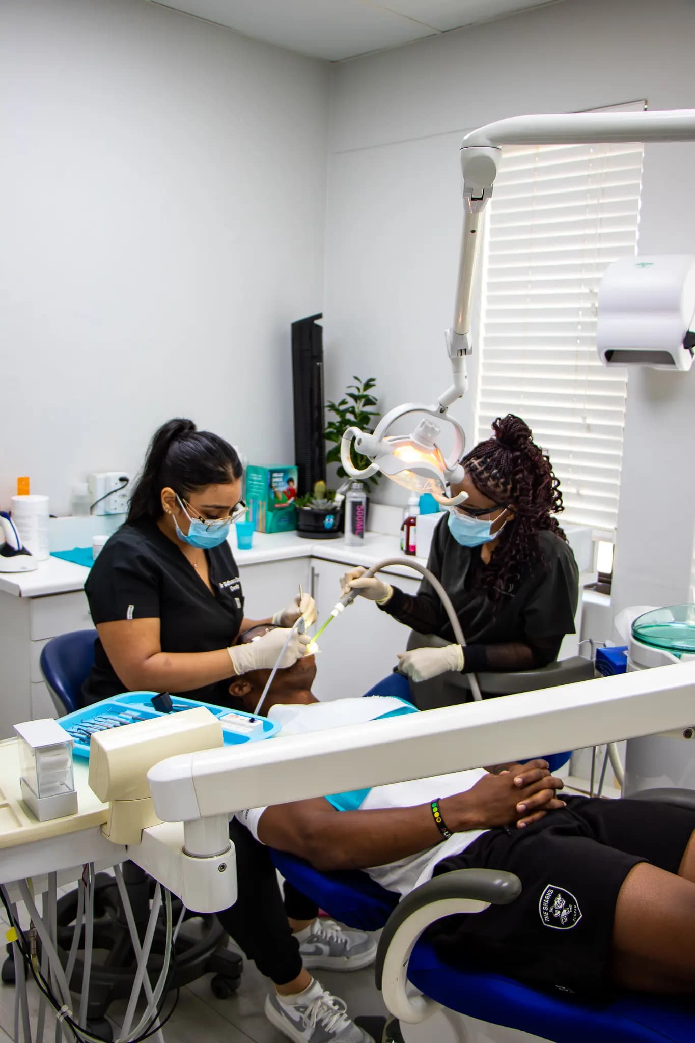 Dentist and assistant treating a patient in a wide surgery