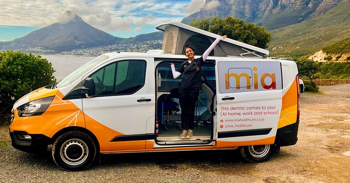 The orange and white Mia mobile clinic van parked roadside with its pop-up roof open