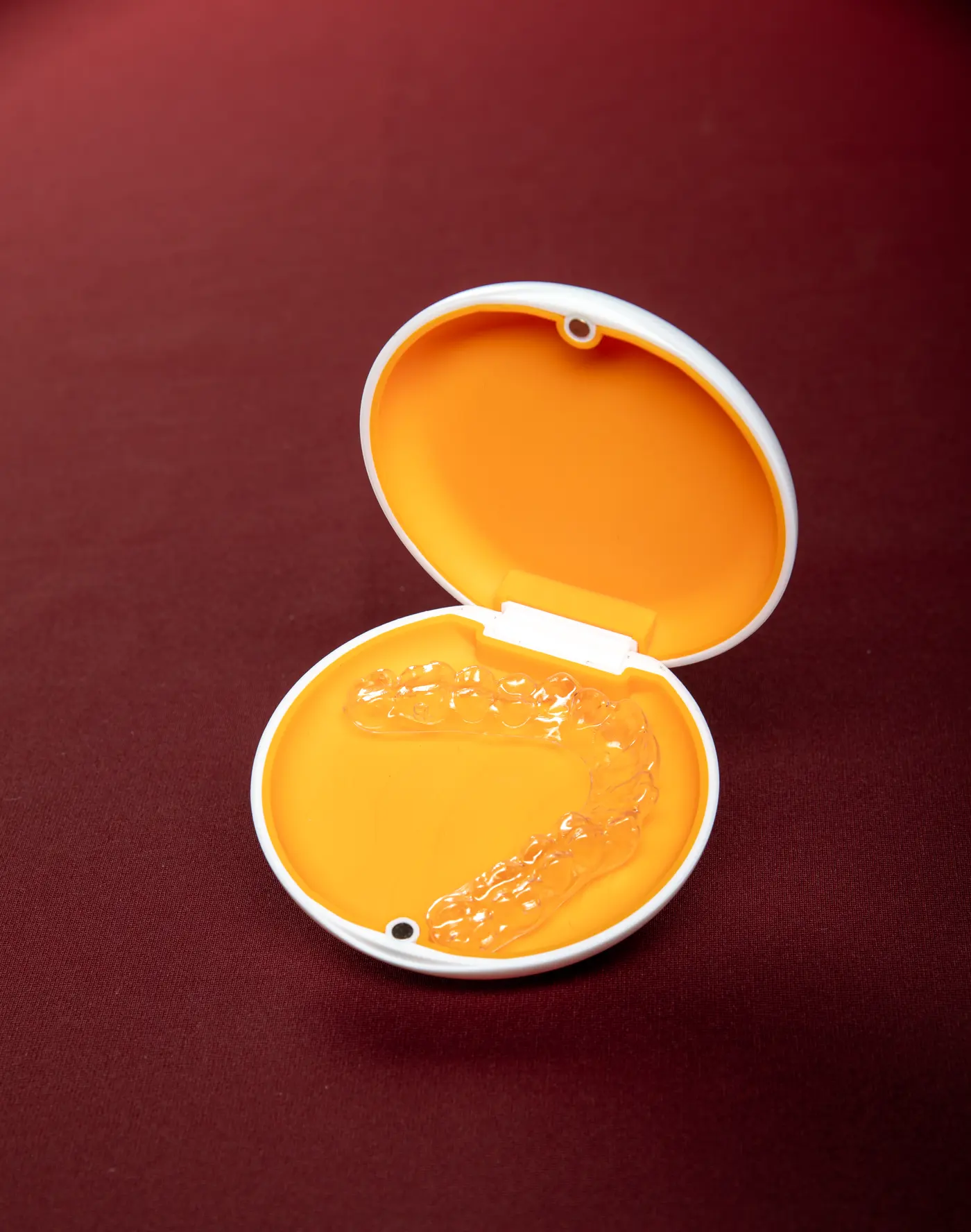 An open Mia aligner case with clear trays
