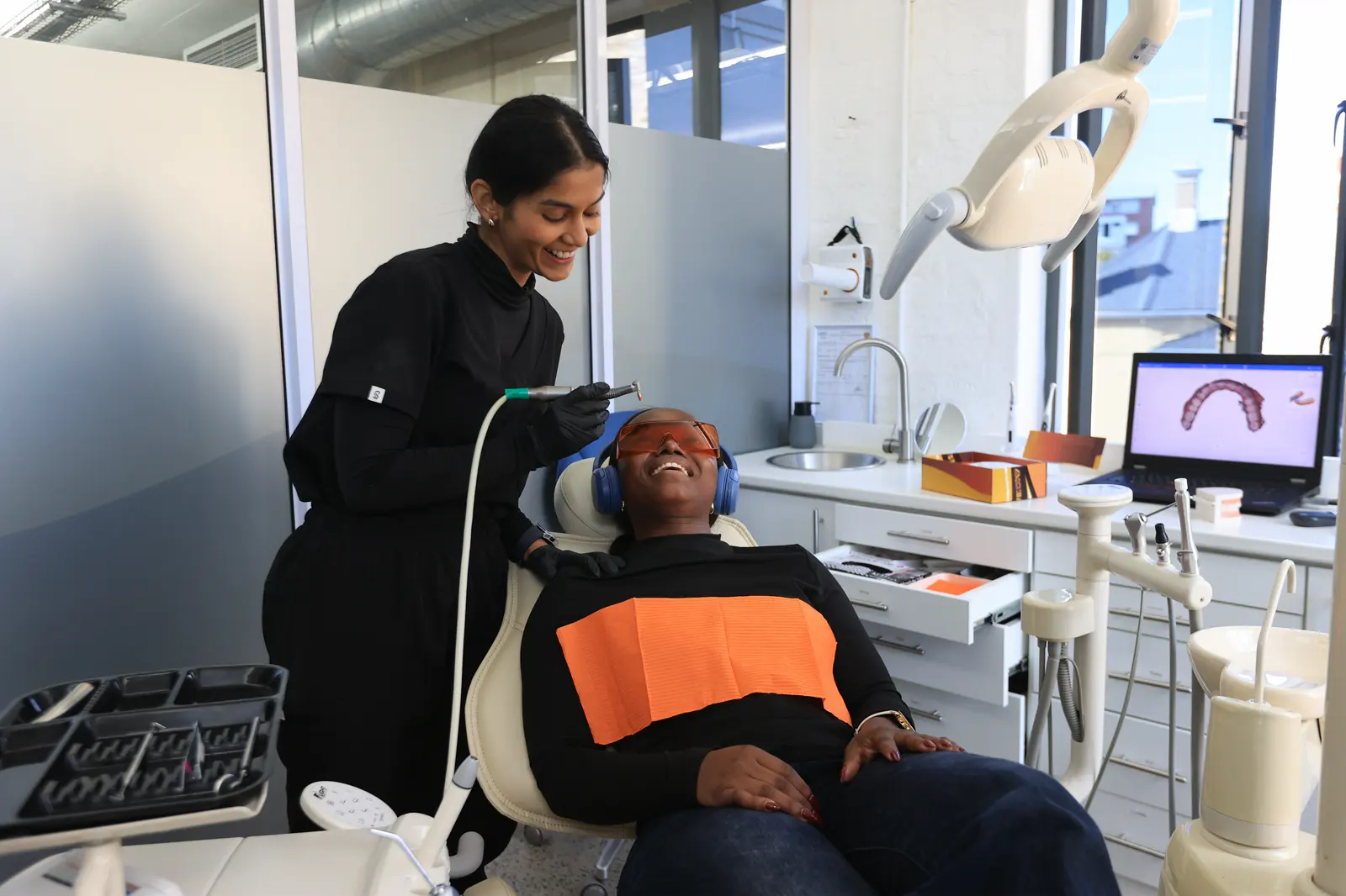A Mia dentist reviewing a scan on a monitor with a patient in the chair