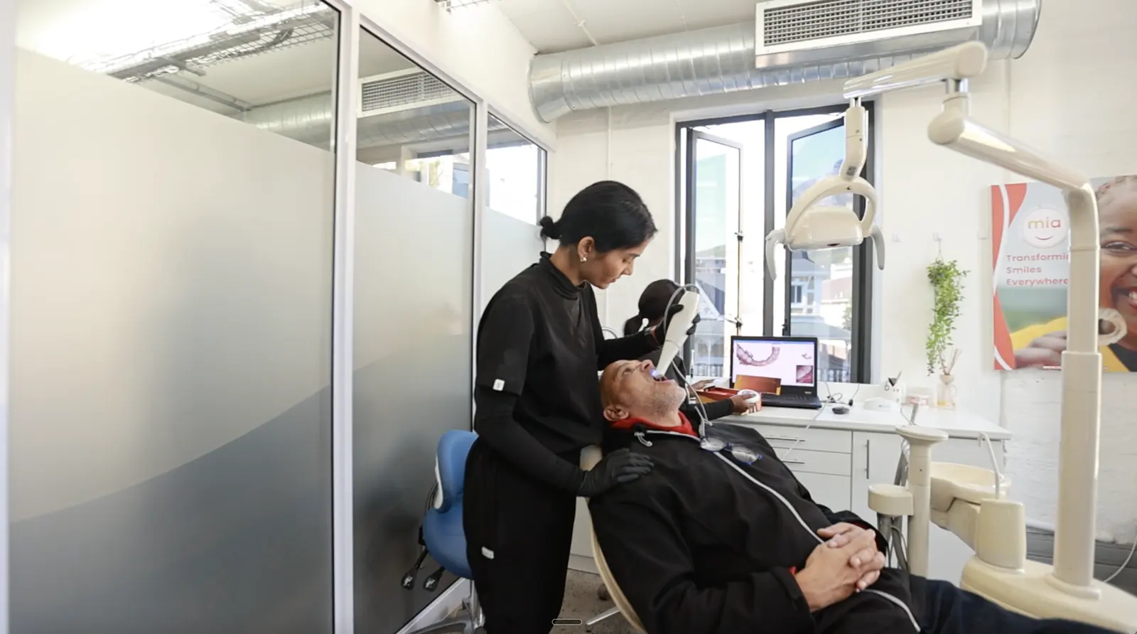 A Mia dentist treating a patient in the clinic