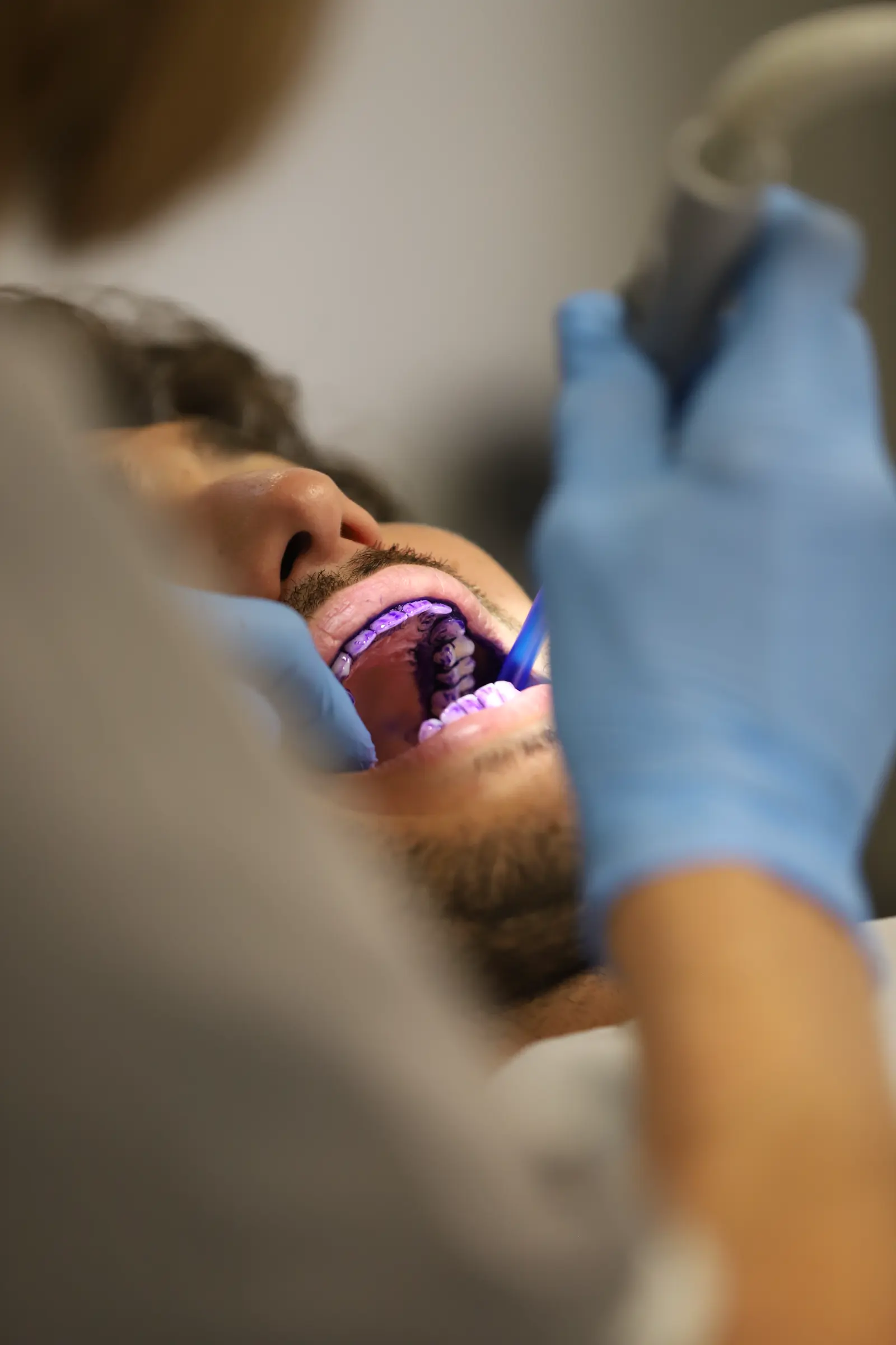 A dentist scanning a patient's teeth