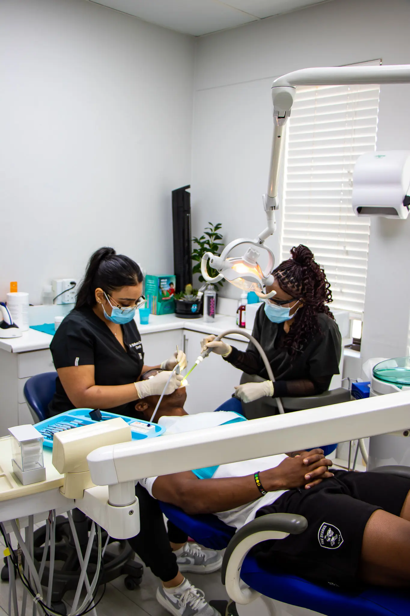 Dentist and assistant treating a patient in a wide surgery