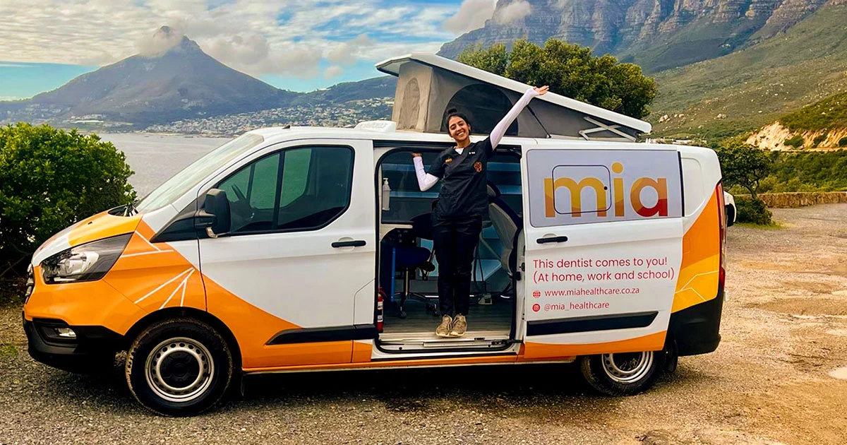The orange and white Mia mobile clinic van parked roadside with its pop-up roof open